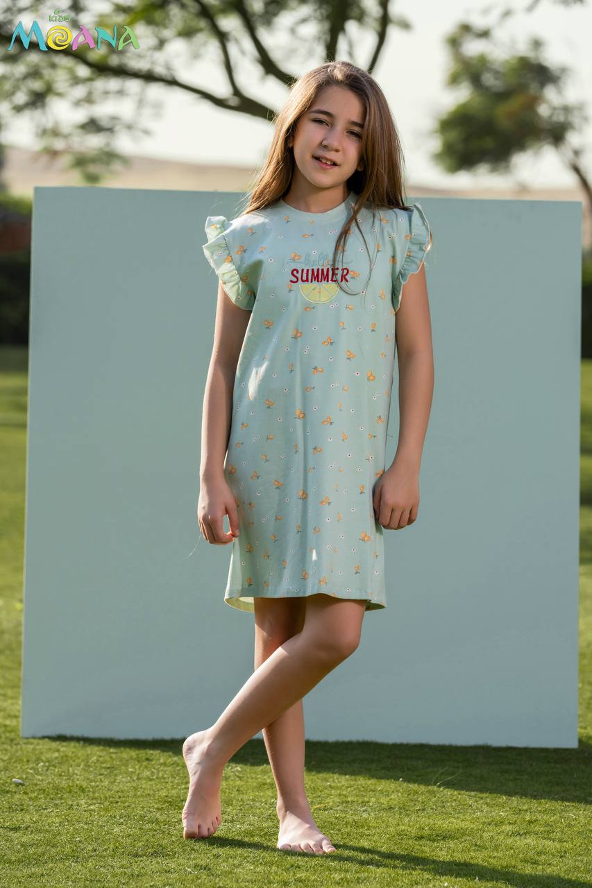 Young girl wearing a light blue dress with 'SUMMER' print, standing on grass.