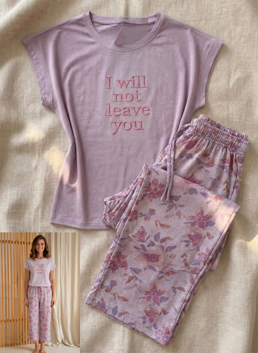 Purple t-shirt with 'I will not leave you' text and floral pants on a beige background.